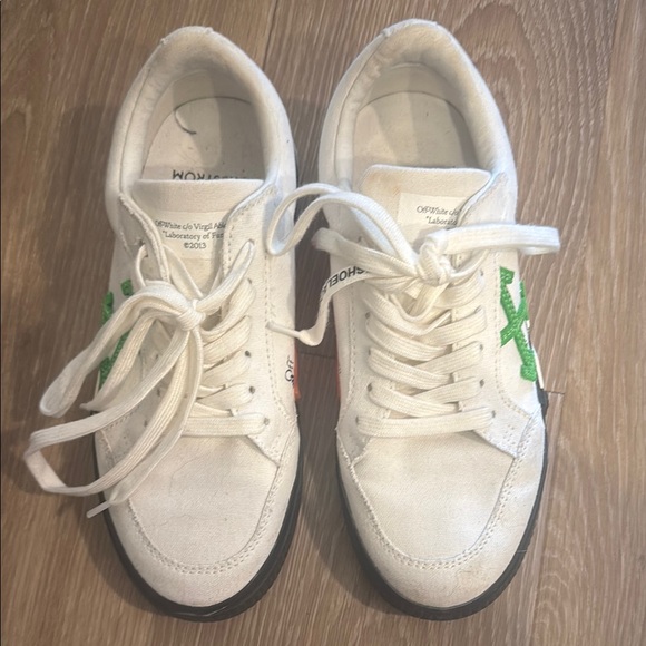 Off-White Athletic Shoes with Green and Black Accents